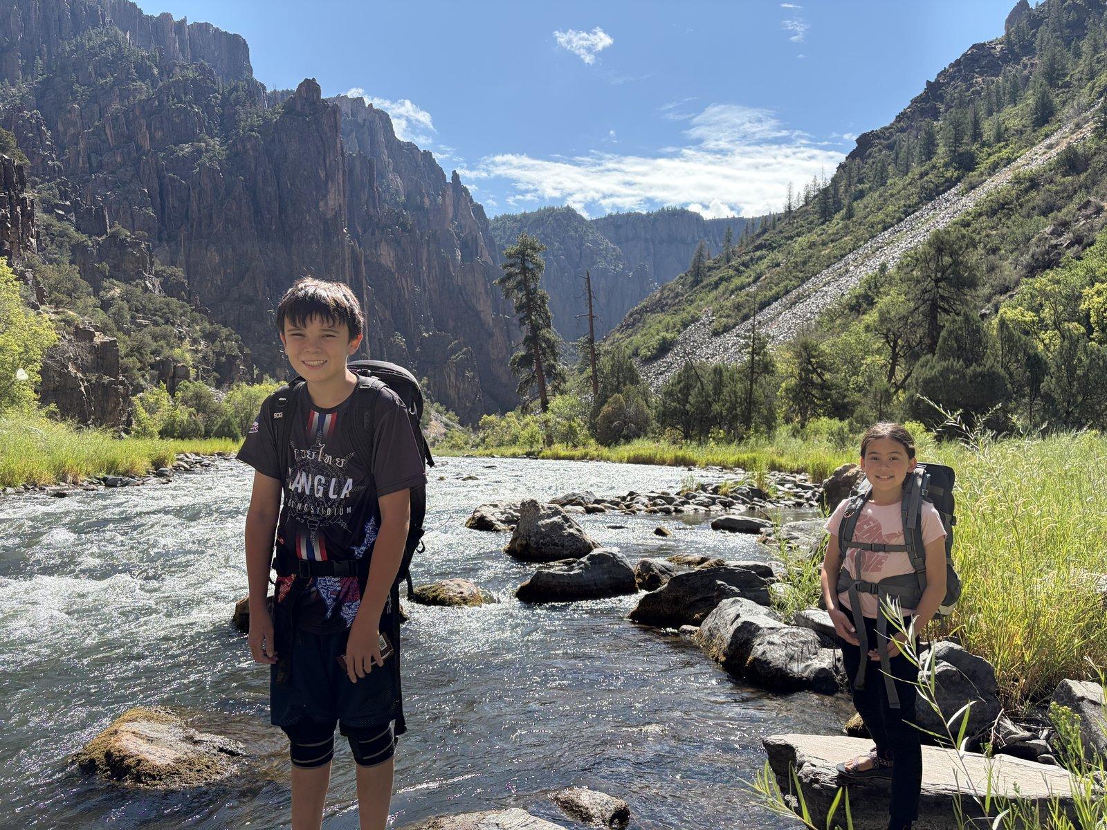 Black Canyon of the Gunnison — the kids at the river with packs on.