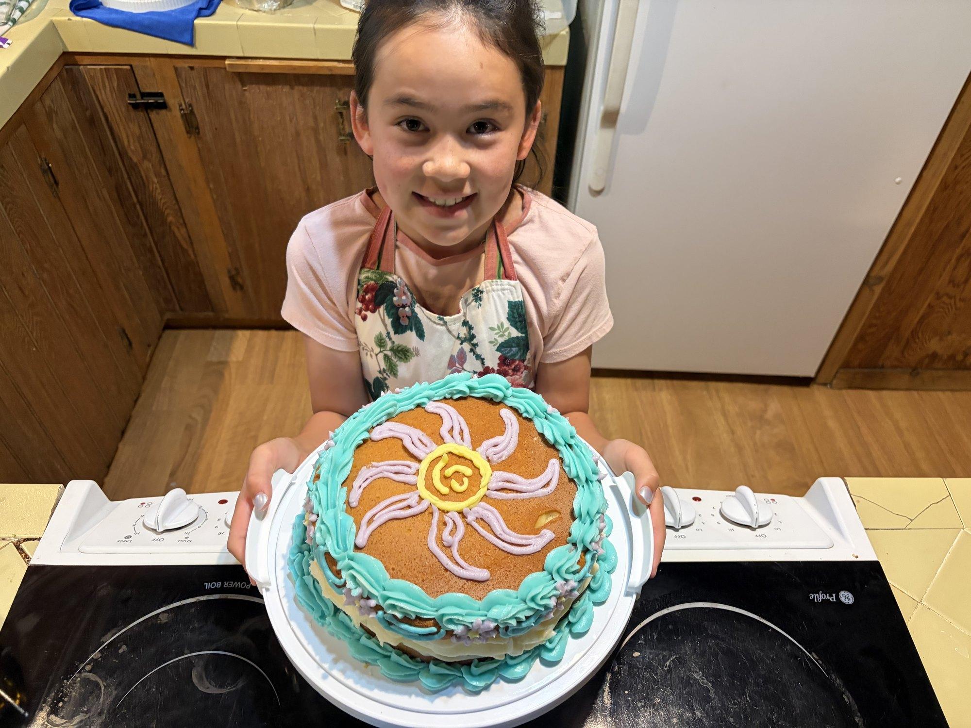 Serene with a cake she baked and decorated herself.