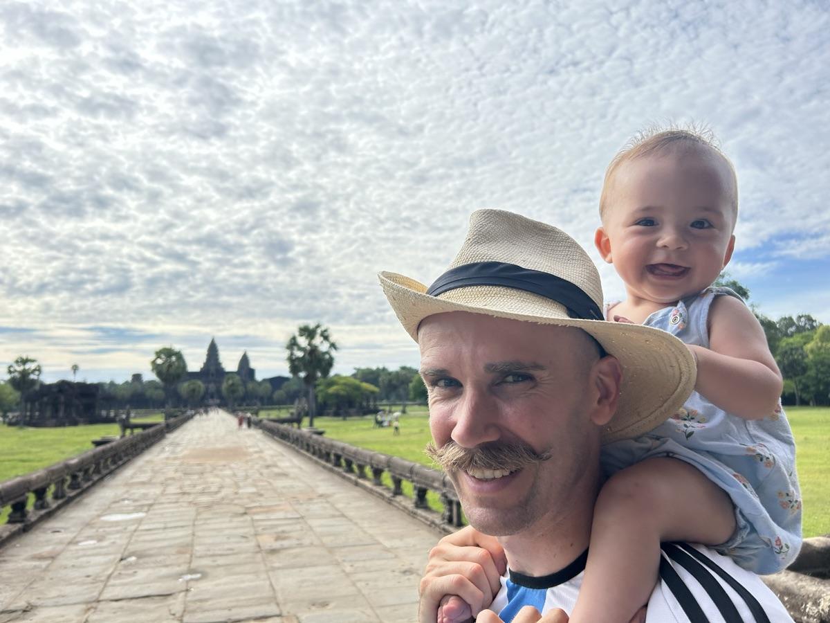 Jordan with one of his kids on his shoulders, on the causeway at Angkor Wat.